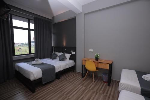 Ένα ή περισσότερα κρεβάτια σε δωμάτιο στο DJ Citi Inn Premier