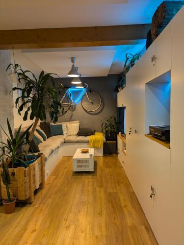 a living room with a couch and a bike on the wall at La promenade in Rennes