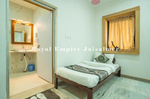 a bedroom with a bed and a mirror at Royal Empire Camp & Resort Jaisalmer in Sām
