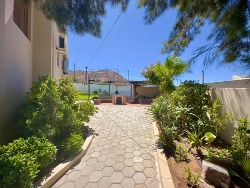 a walkway in front of a house with plants at Kliprand Guest House in Springbok
