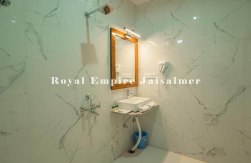 a bathroom with a sink and a mirror at Royal Empire Camp & Resort Jaisalmer in Sām