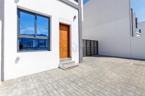 a room with a view of the balcony of a house at Sea-Facing 4BR Villa with Two Assistant Room, Heated Pool and Barbecue Space, Al Dana Island, Fujairah by Deluxe Holiday Homes in Fujairah