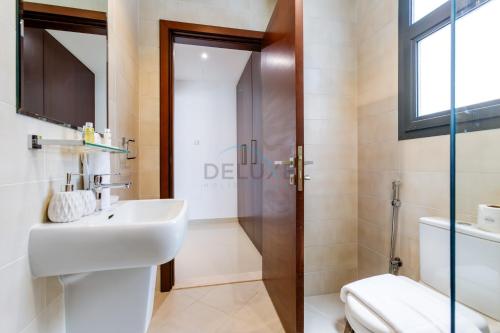 a bathroom with a sink and a shower at Sea-Facing 4BR Villa with Two Assistant Room, Heated Pool and Barbecue Space, Al Dana Island, Fujairah by Deluxe Holiday Homes in Fujairah