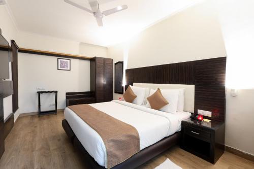 a bedroom with a large bed in a room at SK Premium Park GGN in Gurgaon