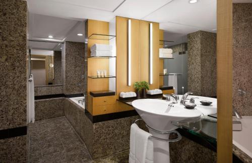 a bathroom with a sink and a toilet and a tub at Westin Josun Seoul Hotel in Seoul
