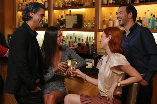 a group of people standing around a bar at InterContinental At Doral Miami by IHG in Miami