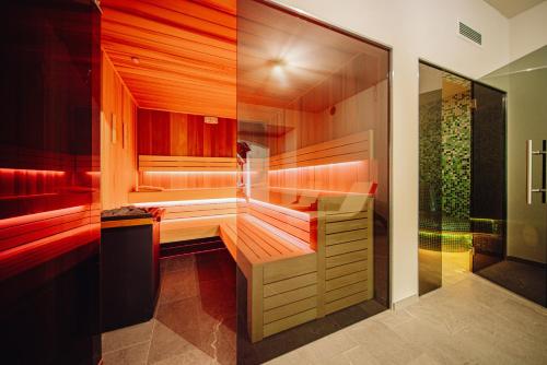 a sauna with red lighting in a bathroom at Park Hotel Kur & Spa in Świeradów-Zdrój