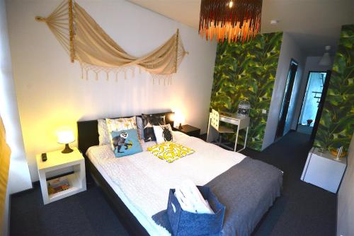 a bedroom with a bed and a chandelier at Hotel Biscuit in Cluj-Napoca