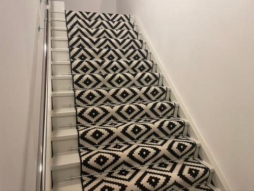 a stairway with a patterned carpet in a room at La Barca di Grano in SantʼAgata Bolognese