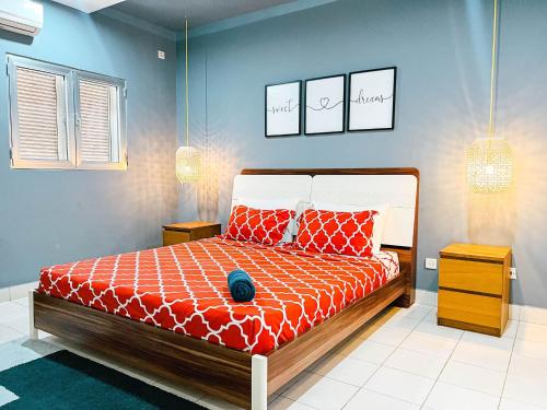a bedroom with a bed and two pictures on the wall at Apartment P - 3 Bedrooms in Belas