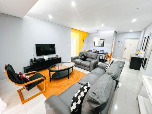 a living room with a couch and a table at Apartment P - 3 Bedrooms in Belas