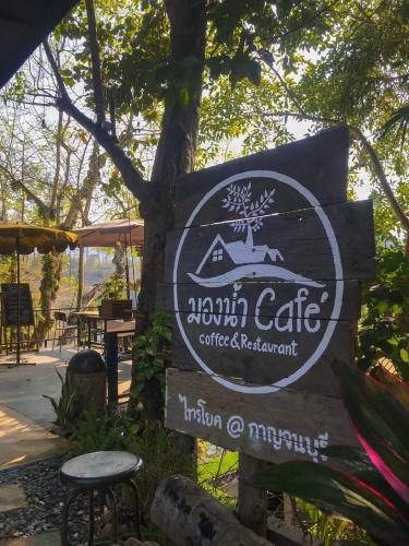 a sign for anantoni adventure cafe with a tree at มาตาบุรี ริเวอร์เเควรีสอร์ท in Ban Gaeng Cho