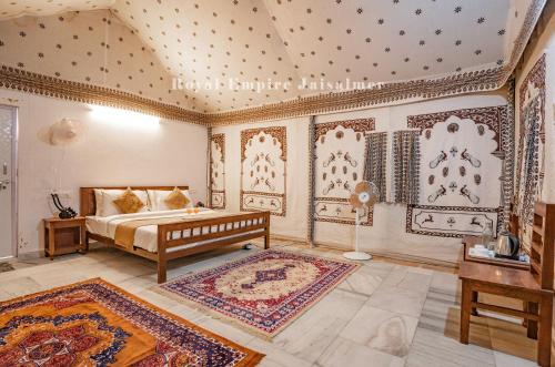 a bedroom with a bed in a room with a ceiling at Royal Empire Camp & Resort Jaisalmer in Sām