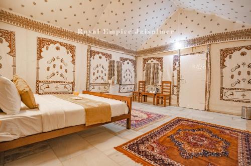 a bedroom with a bed and a rug at Royal Empire Camp & Resort Jaisalmer in Sām