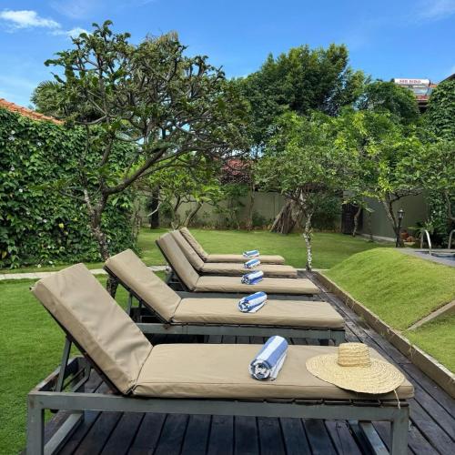 a patio with two lounge chairs and a table at Seahorse Hotel & Spa in Negombo