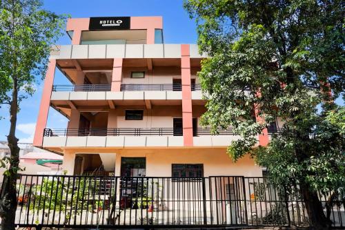 a building with a black fence in front of it at Super Hotel O GMS Road Ballupur Chowk in Dehradun