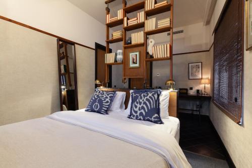 a bedroom with a bed with blue and white pillows at Communal Hotel Kutaisi in Kutaisi