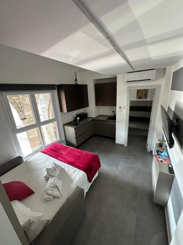a bedroom with a large bed with a red blanket at Suite degli Archi - Genova Fronte Acquario in Genova