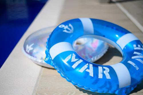 a blue and white life vest sitting on a table at Pool Villa Mito - Pool Villa 水戸 in Mito