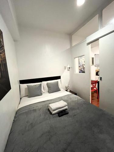 a bedroom with a large bed in a room at BGC Suites EDSA Makati in Manila