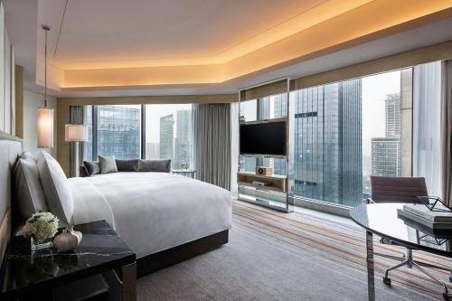 a bedroom with a large white bed and a large window at JW Marriott Hotel Chengdu in Chengdu