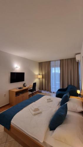 a large bedroom with a large bed and a desk at Maris in Novi Vinodolski