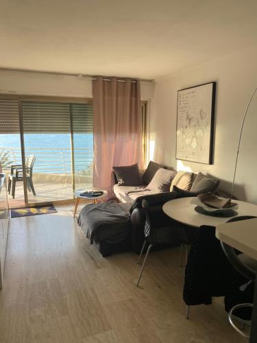 un salon avec un canapé et une table dans l'établissement Le chantilly, à Cagnes-sur-Mer