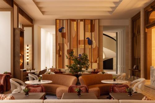 a restaurant with tables and chairs in a room at Capella Taipei in Taipei