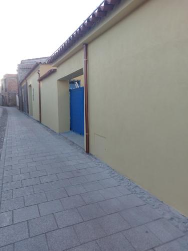 an empty sidewalk next to a building at Su Furriadroxiu in San Vito