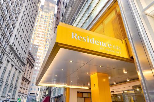 a building with a yellow sign for aresden inn at Residence Inn by Marriott New York Downtown Manhattan/World Trade Center Area in New York