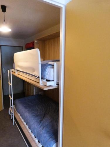 Cette chambre dispose de lits superposés et d'un ordinateur portable sur une étagère. dans l'établissement Residence Le Thymel - 2 pièces cabine 4 personnes exposé Est MAE-8644, à Valloire