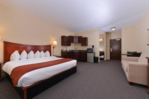 a hotel room with a large bed and a couch at Blue Spruce Inn-Meeker, Colorado in Meeker