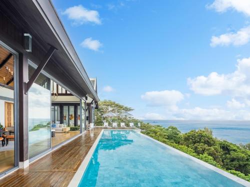 an infinity pool in a house with a view of the ocean at Malaiwana Villas in Nai Thon Beach