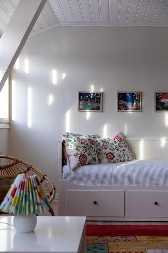 a bedroom with a white bed with pillows at Stay North - Marjaniemi in Salo