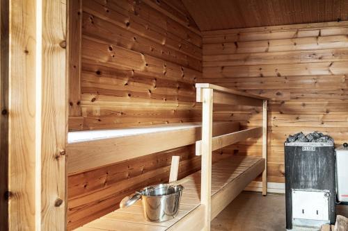 a sauna with wooden walls and wooden shelves at Stay North - Marjaniemi in Salo