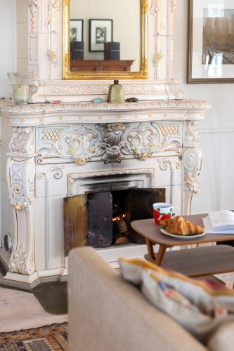 a living room with a fireplace with a plate of food at Stay North - Marjaniemi in Salo