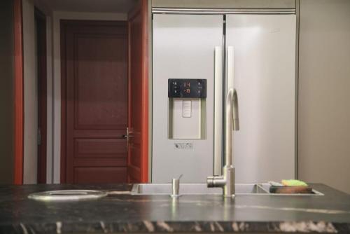 - un réfrigérateur en acier inoxydable dans une cuisine avec un comptoir dans l'établissement Les Hortensias, maison de ville, à Capbreton