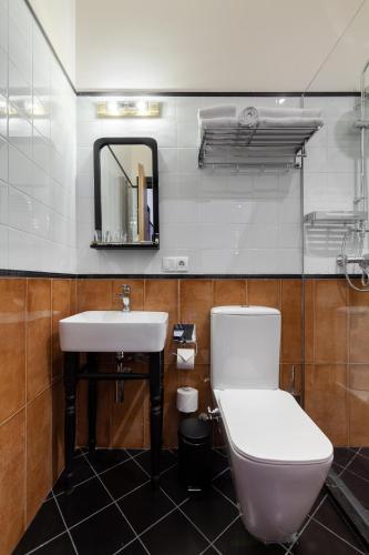 a bathroom with a toilet and a sink at Communal Hotel Kutaisi in Kutaisi