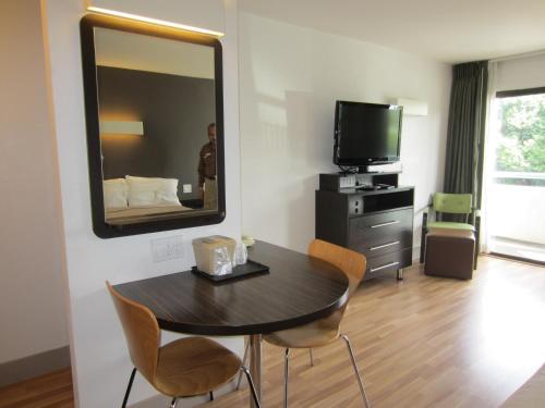 a room with a table and a mirror and a bedroom at Studio 6-Concord, CA in Concord