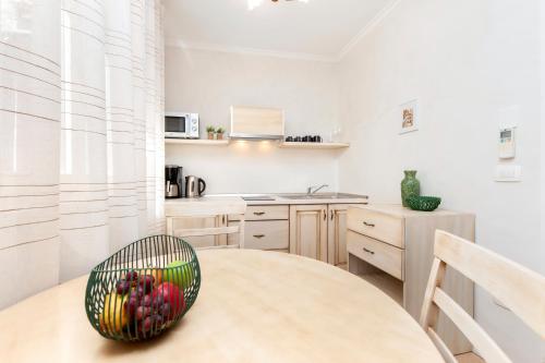 a kitchen with a table with a bowl of fruit on it at Casa Matteotti in Rovinj