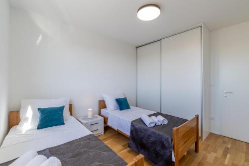 Postel nebo postele na pokoji v ubytování Apartment Solin Mezanovci