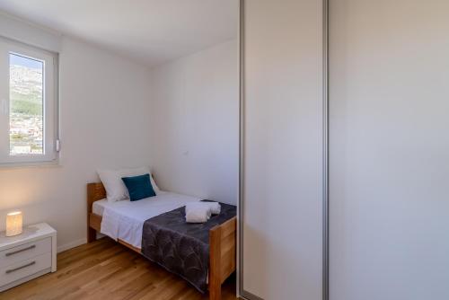 Postel nebo postele na pokoji v ubytování Apartment Solin Mezanovci