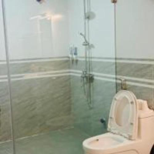 a bathroom with a toilet and a glass shower at SH Homestay - Venuestay in Sóc Sơn