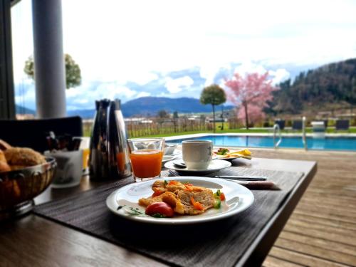 a table with a plate of food and a drink at Mosers Blume Relax & Genuss Hotel in Haslach im Kinzigtal