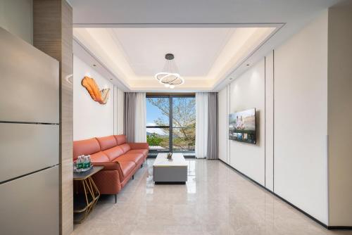 a living room with a couch and a table at Puhai Sea View Apt by Hailan Tour at Sanya Yazhou Bay#only 100 meters to Beach and Sea Swimming Area in Sanya