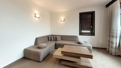 a living room with a couch and a coffee table at Wine & Spa Complex Starosel in Starosel