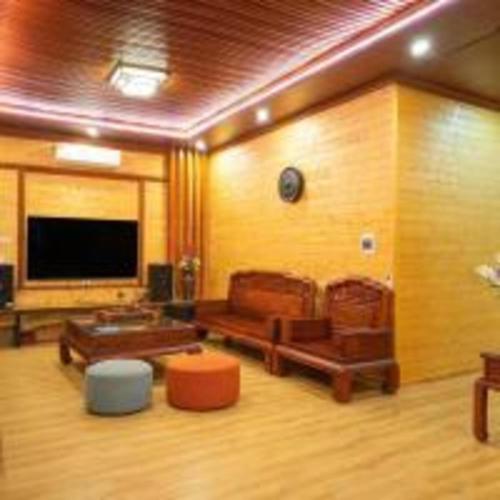 a living room with furniture and a flat screen tv at SH Homestay - Venuestay in Sóc Sơn