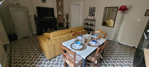 un salon avec une table et un canapé dans l'établissement Le Colbert - T2 Centre Ville, à Nîmes