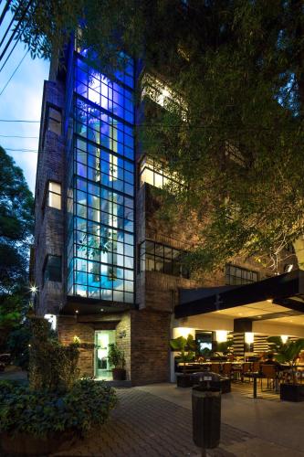 a large building with blue lights on it at FlowSuites Polanco in Mexico City