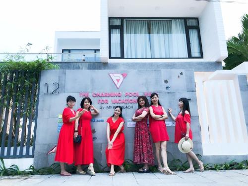 a group of women standing in front of a wall at Charming Luxury Beach Villa Da Nang in Da Nang